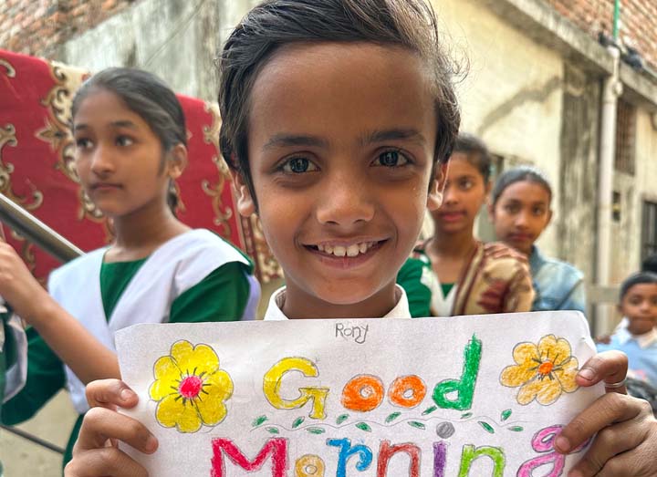 Image of Boy with Good Morning Sign